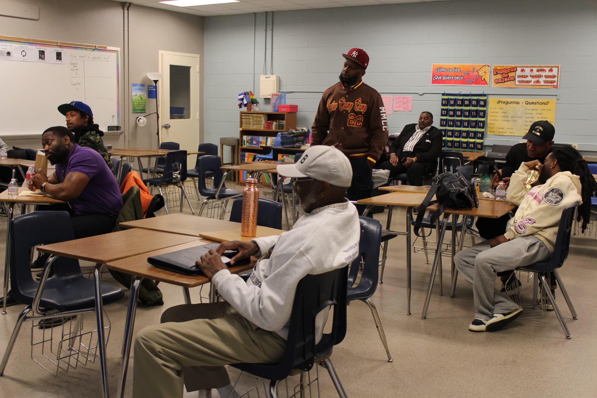 Men seated in a classroom during a summit breakout session